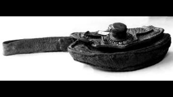 Tibetan leather flint container with applique of silver, set with jade.