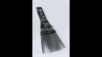 West African wooden comb with raffia binding of geometric designs.