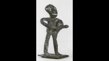 Ashanti bronze figure of a man beating a drum.