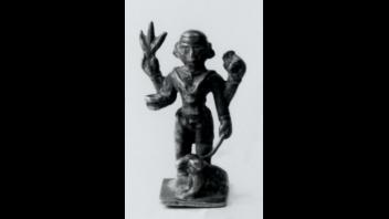 Antique Indian bronze multi-armed figure standing with a dog.