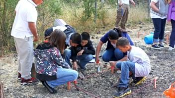 Students set up a unit during a hands-on archaeology lesson.