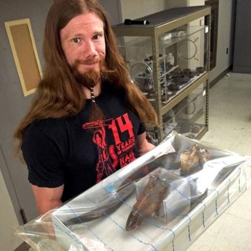 museum volunteer Chris Swanson with anoxic environment of antelope skull